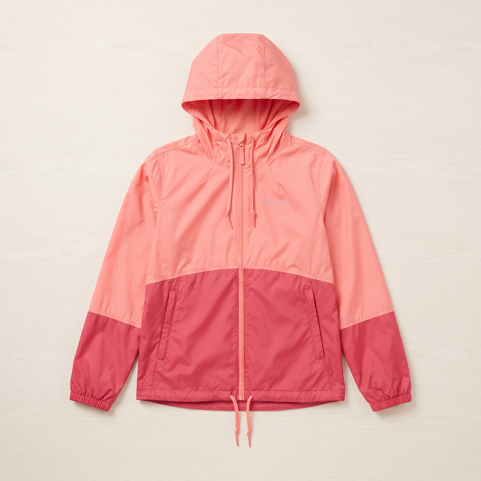 Kids waterproof windbreaker jacket by Columbia in two-tone pink on wood